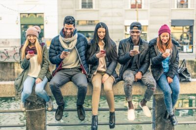 group of friends using smartphones