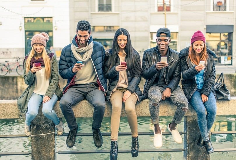group of friends using smartphones