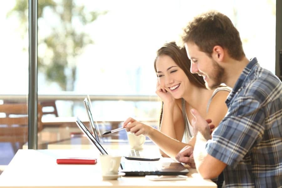 young couple on laptops